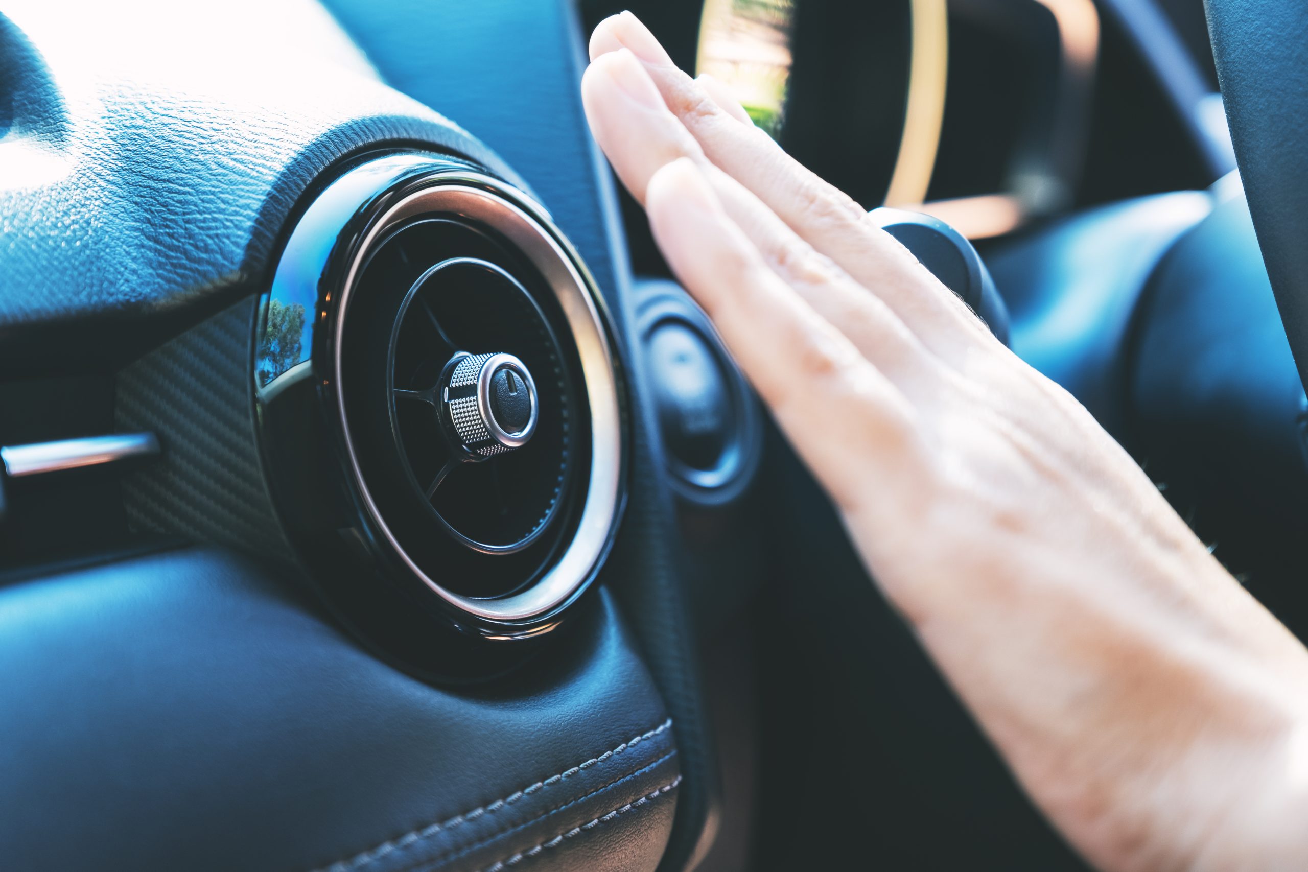 Closeup image of a hand checking the air conditioner system in t Closeup image of a hand checking the air conditioner system in the car